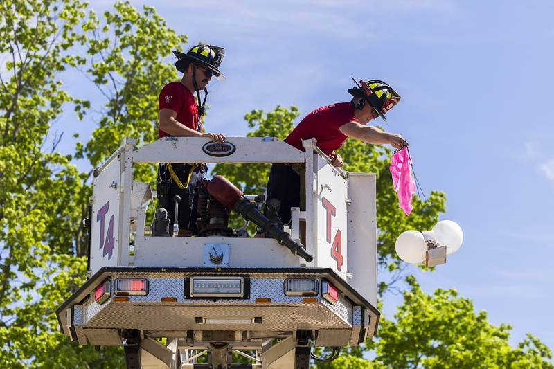 Sterling firefighters Nick Simpson (left) and Kurt Landis drop the first egg space lander Friday, May 16, 2025, at Sterling’s Lincoln School.