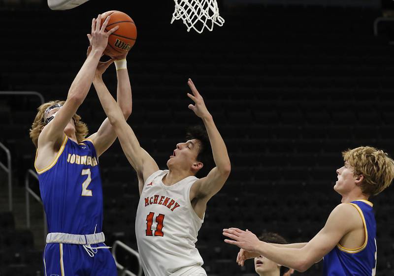 Johnsburg's lan Boal grabs a rebound over McHenry's Hayden Stone during a non-conference basketball game Sunday, Nov. 27, 2022, between Johnsburg and McHenry at Fiserv Forum in Milwaukee.