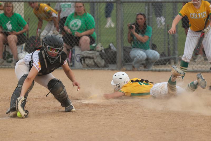 Angelina Cole (4) of Providence successfully slides into home base whilst Lilia Flores (2) of Tinley Park attempts to tag her out on Tuesday, June 3, 2025 at Ottawa High School in Ottawa.
