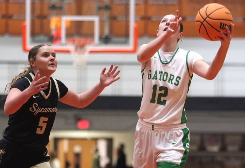 Crystal Lake South’s Gaby Dzik, right, gets past Sycamore’s Grace Amptmann in girls IHSA Class 3A Sectional basketball on Tuesday, Feb. 24, 2026, at Crystal Lake Central High School in Crystal Lake.
