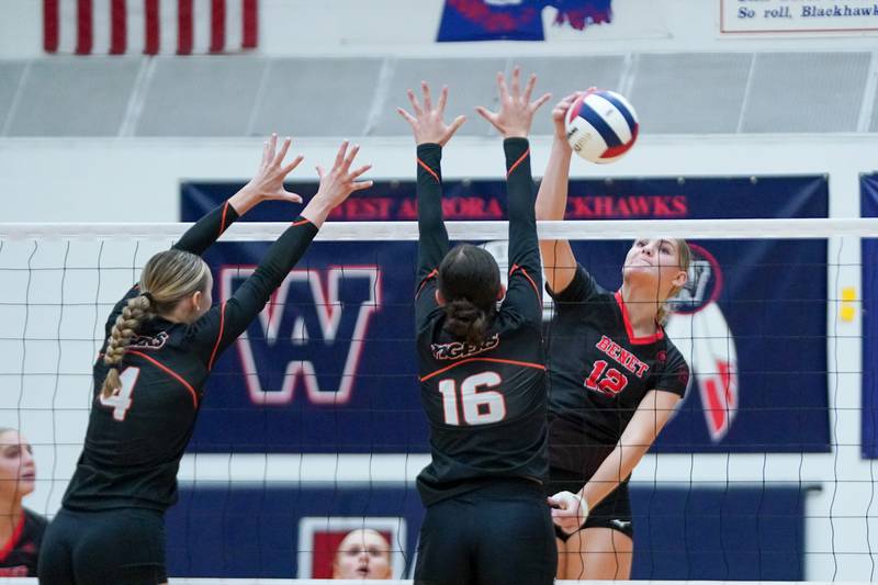 Benet’s Carolyn ( Lynney) Tarnow (12) goes up for a kill attempt against Wheaton Warrenville South's Tessa Gonzalez (16) during a Class 4A West Aurora Sectional semifinal volleyball match at West Aurora High School on Tuesday, Nov. 5, 2024.