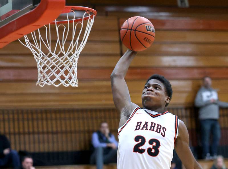 DeKalb’s Davon Grant goes in for a dunk in front of Kaneland's Bradley Franck during their game Monday, Feb. 12, 2024, at Huntley Middle School in DeKalb.