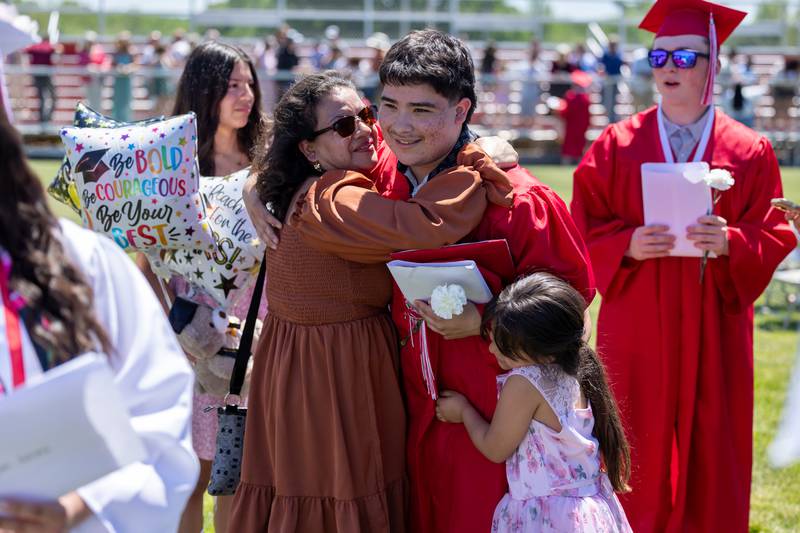 Javi Serrano embraces family after graduating on Sunday, May 18, 2025 at Hall High School in Spring Valley.