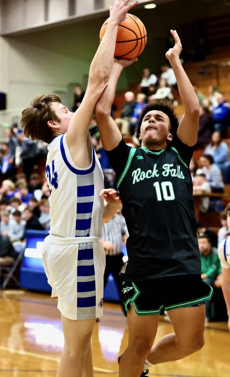 Princeton's Ryan Jagers gets a piece of the rock on this second-half shot by Rock Falls' Z'viyon Martin in Tuesday's game at Prouty Gym. The Rockets won 61-58.