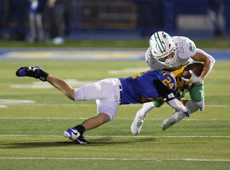 York's Henry Duda (26) is tackled by Lyons' Ian Collins (24) during the varsity football first-round 8A playoff game between York and Lyons Township on Friday, Oct. 31, 2025 in Western Springs, IL.