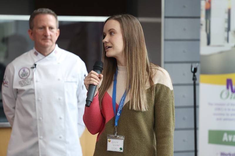 Janelle Winters, of the USDA, talks with high school students at a nutritional and wellness event hosted by Joliet Junior College on Friday, April 21, 2023 in Joliet.