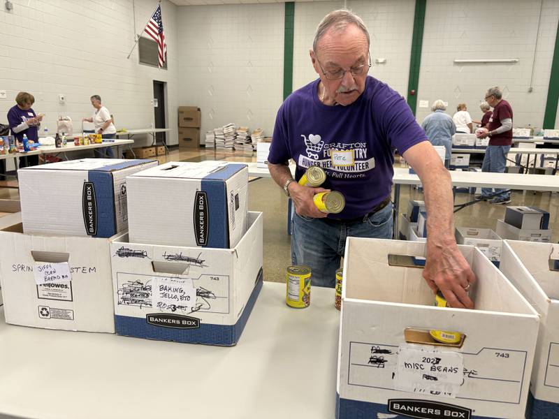 Grafton Food Pantry Volunteer Pete Schilling sorts canned goods at the Huntley Park District Saturday May 9, 2026.