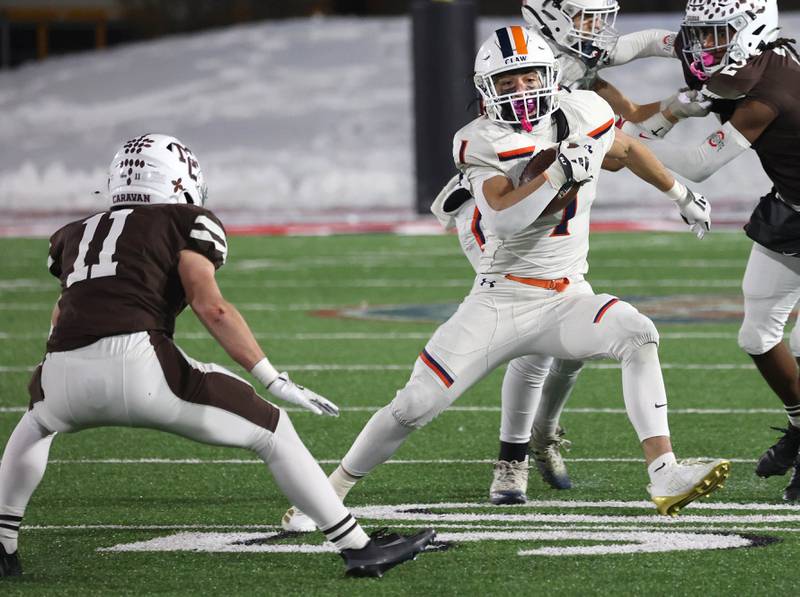Oswego's Teddy Manikas tries to get by Mount Carmel's Cullen Winters Wednesday, Dec. 3, 2025, during their IHSA Class 8A state chamionship game in Huskie Stadium at Northern Illinois University in DeKalb.