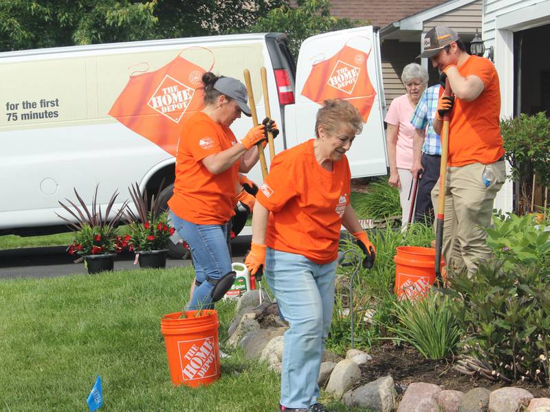 Home Depot personnel get ready to install a flagpole at the home of Ben Jankowski in Woodstock June 6, 2025.