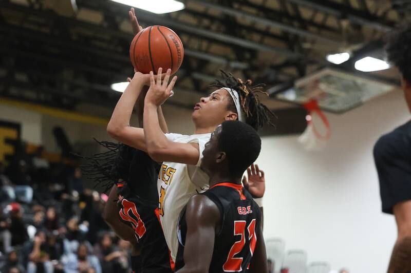 Joliet West’s Tristian Saunders takes the contested shot against Plainfield East on Friday, Dec. 8th, 2023 in Joliet.