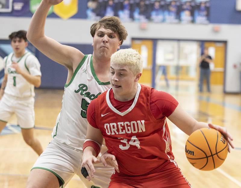 Oregon’s Kade Girton handles the ball against Rock Falls’ Cole Mulnix Wednesday, Feb. 26, 2025, at the Class 2A Regional semifinal at Bureau Valley High School.
