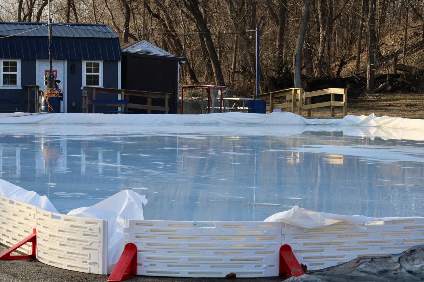 Water pools on the surface and collects underneath the ice at the Page Park rink on Thursday. Daytime temps got up to 63 degrees, the National Weather Service said.
