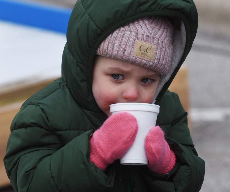 Emmy Stack, 3, of Glen Ellyn sips hot cocoa during Frozen Fest in Glen Ellyn Saturday.