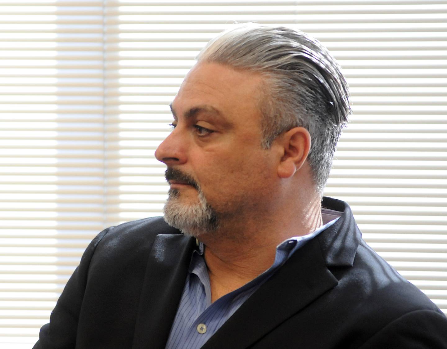 Tony Colatorti listens to proceedings Thursday, April 14, 2022, during a hearing of McHenry County electoral board at the McHenry County Administration Building in Woodstock. The board was to determine if Colatorti can remain on the ballot following an objection by William Brogan and Joel Brumlik over his qualifications to run for the position of McHenry County sheriff.