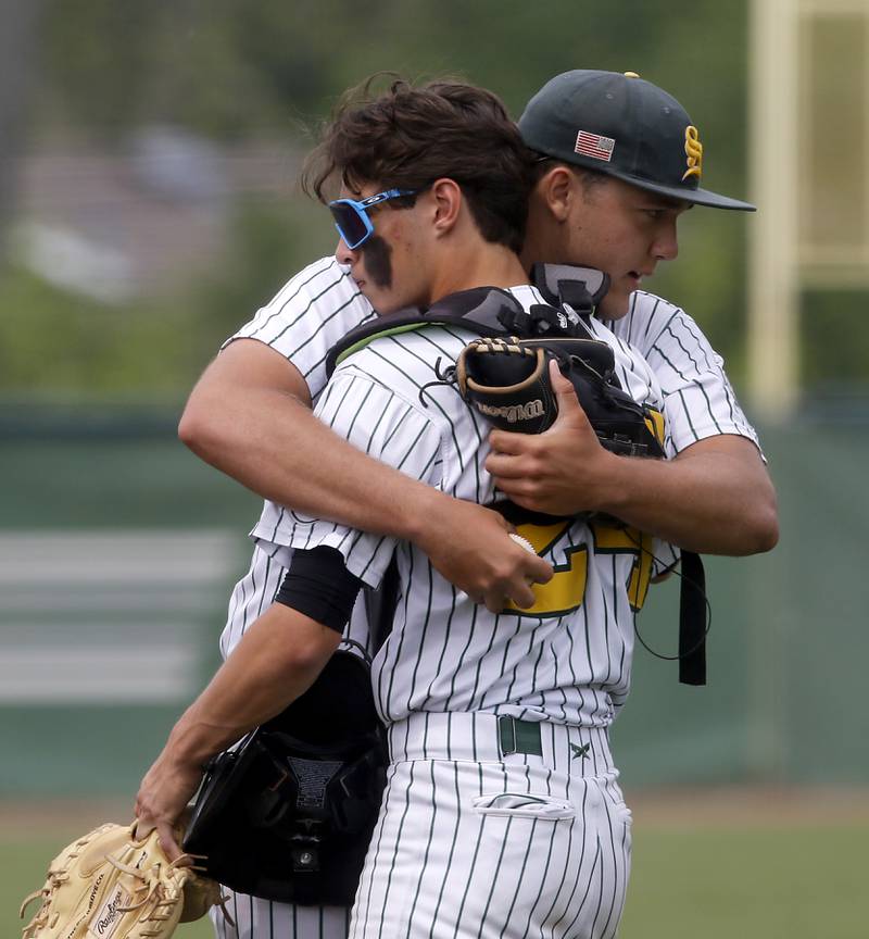 Crystal Lake South's Devin De Loach hugs his catcher, Jackson Lee, as they take the filed for the IHSA Class 3A Grayslake Central Sectional Championship baseball game against Cary-Grove on Saturday, June 7, 2025, at Grayslake Central High School.