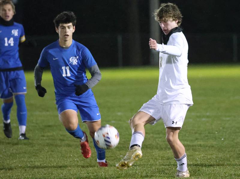 Sycamore's Maddux McLaughlin kicks the ball in front of Burlington Central’s Niko Guzman Tuesday, Oct. 21, 2025, during their IHSA Class 2A regional semifinal match at Burlington Central High School.