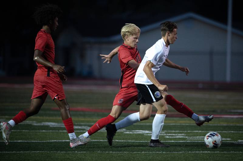 Manteno's Ben Froeschle controls the ball as Bradley-Bourbonnais' Cade Hill, center, defends in a game on Tuesday, September 16, 2025.