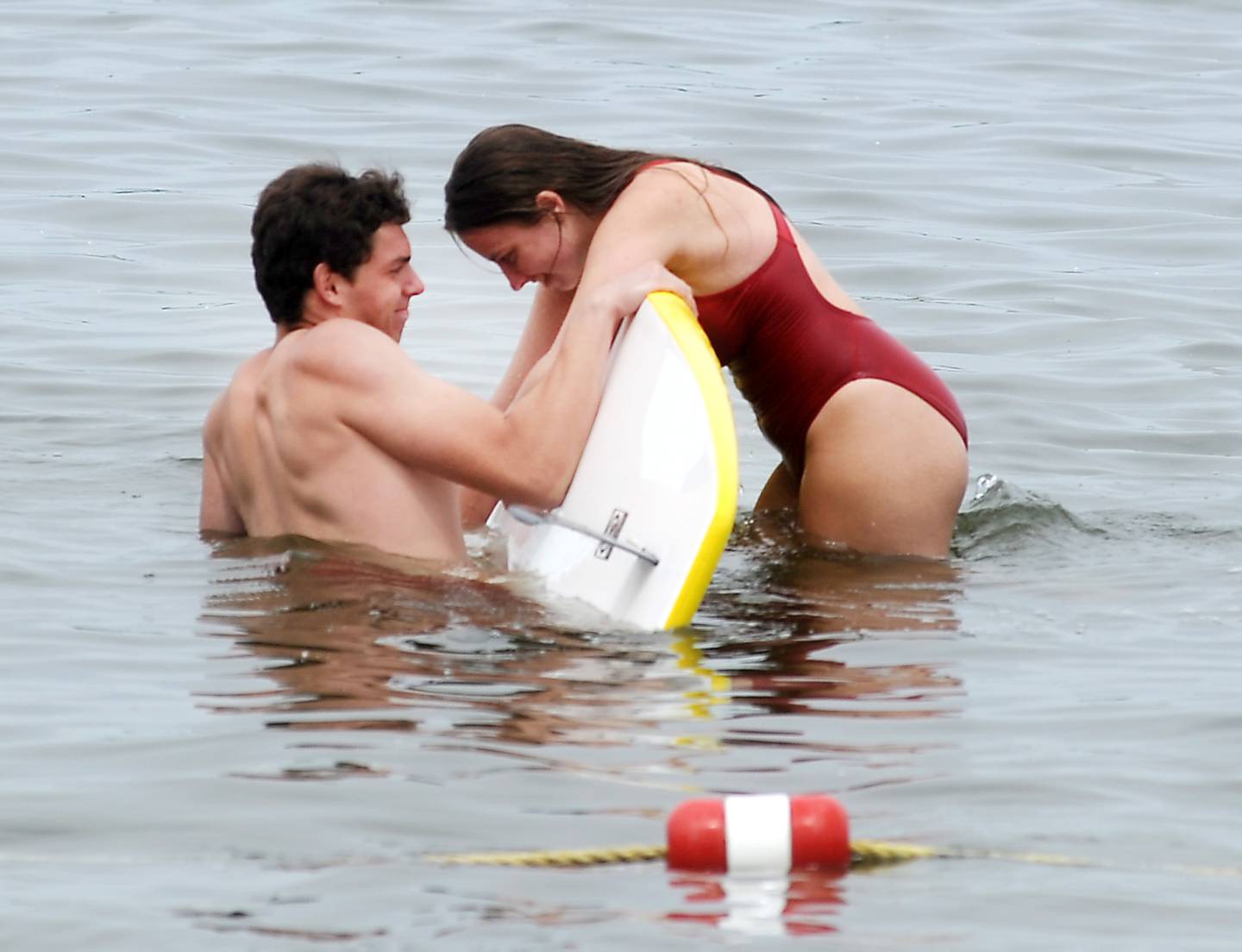 Lifeguard instructor Tommy Landt demonstrates a rescue technique with Mareena Berge Wednesday, June 1, 2022, during a lifeguard training session at Crystal Lake's Main Beach.