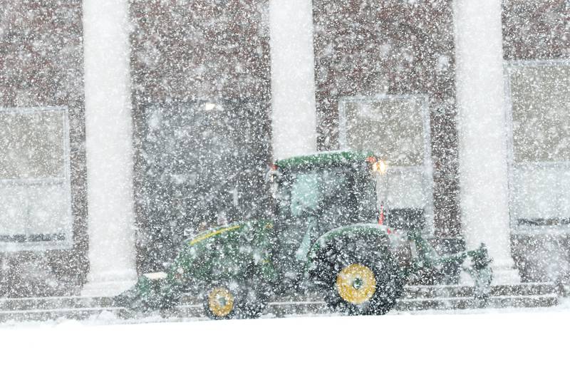 Heavy, wet snow fell in front of the Oregon Junior-Senior High School late Thursday afternoon while a school worker tried to clear the sidewalk as a winter storm moved through the region. Several inches of snow was forecast.
