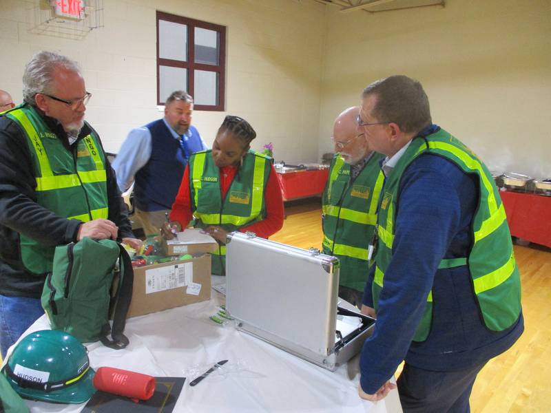 Members of the new Joliet Certified Emergency Response Team go through materials issued to the team at a gathering on Thursday. May 22, 2025