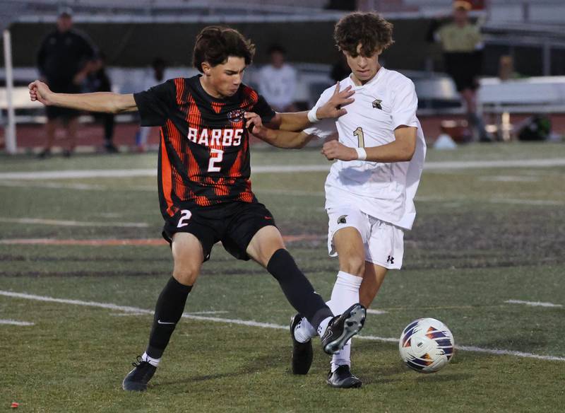 Sycamore's Noah Daykin and DeKalb's Zach Murray go after the ball during their game Thursday, Oct. 10, 2024, at DeKalb High School.