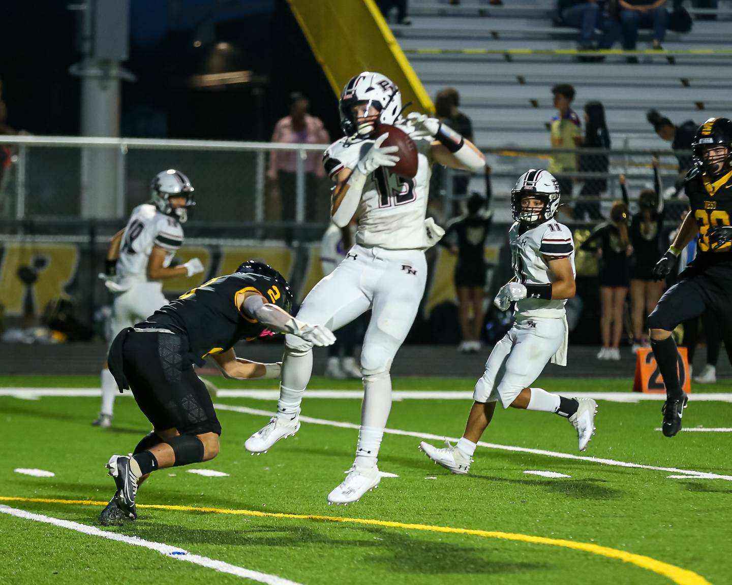 Plainfield North's Braxton Bartz (13) comes down with a reception during football game between Plainfield North at Joliet West.  Sept 15, 2023.