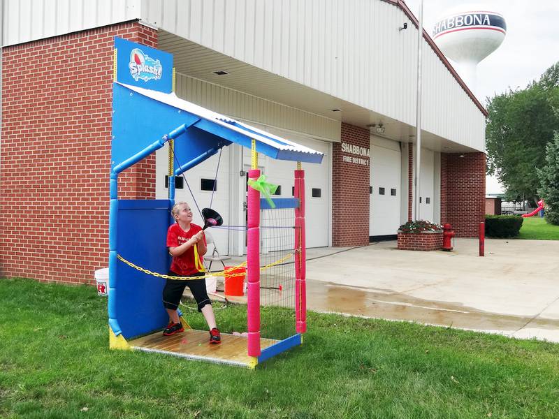 Blake McRoberts, 9, of Shabbona, plays with the Splash! water balloon slingshot during the open house wellness event of the United Neighborhood Center in Shabbona on Saturday, Sept. 20.
