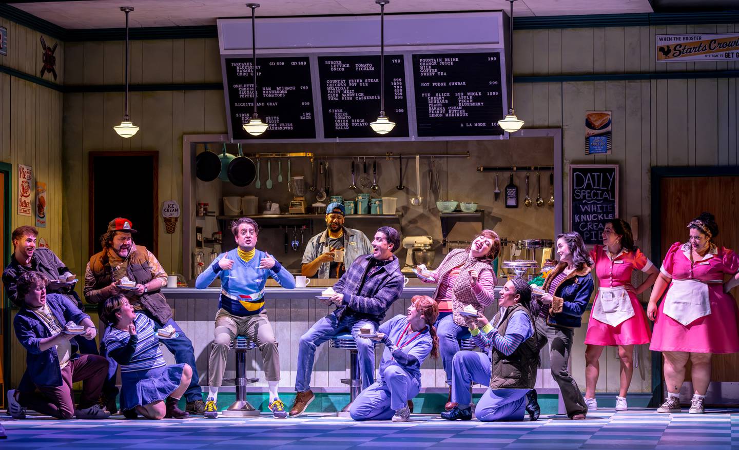 PT_Waitress_12_credit Brett Beiner Photography.jpg Ogie (Jackson Evans, center/left, blue sweater) declares in front of the entire diner that Dawn, his waitress and love interest, is never, ever going to get rid of him in Paramount Theatre’s Waitress. Paramount’s is the first Chicago-area production of this hit Broadway musical, with music and lyrics by Sara Bareilles, directed by Katie Spelman. Performances run through March 30, 2025. For tickets, visit paramountaurora.com or call (630) 896-6666. Photo credit: Brett Beiner Photography