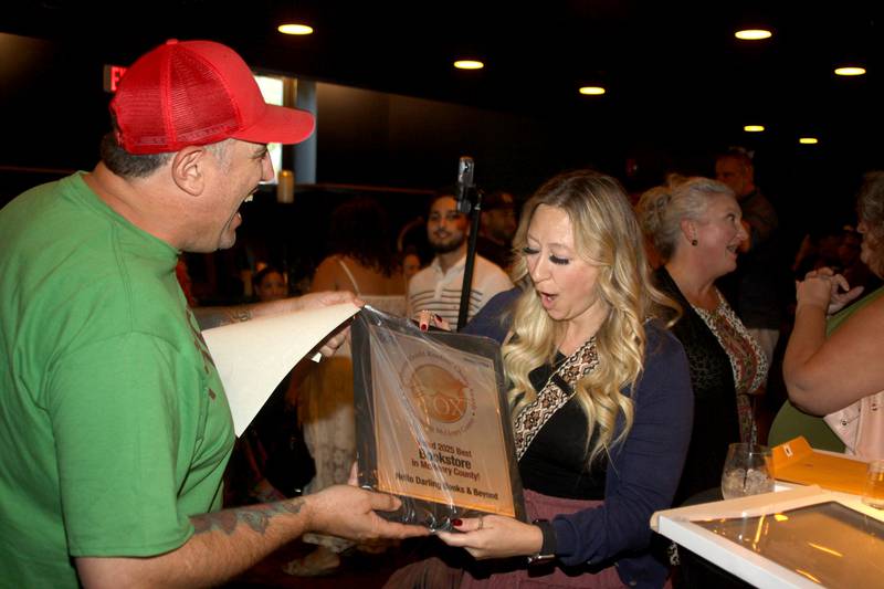 Radio personalities Joe Cicero and Tina Lawrence admire some of the awards during Shaw Media's Best of the Fox celebration at Lou’s Lounge at the Dole in Crystal Lake on Thursday, Sept. 18, 2025.
