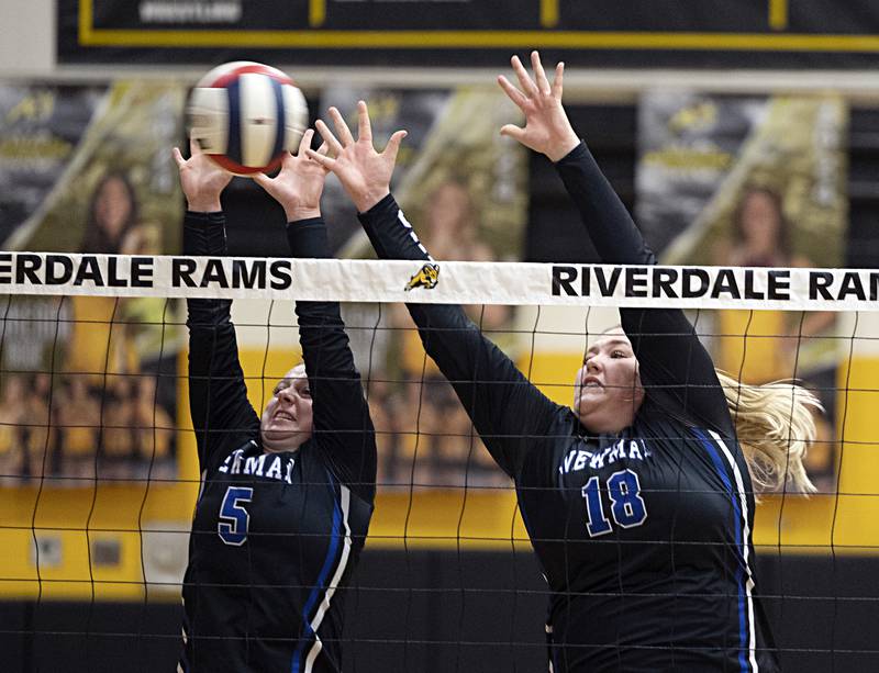 Newman’s Molly Olson (left) and Kennedy Rowzee go up for a block against Rock Falls Thursday, Oct. 26, 2023 in the class 2A regional finals at Riverdale.