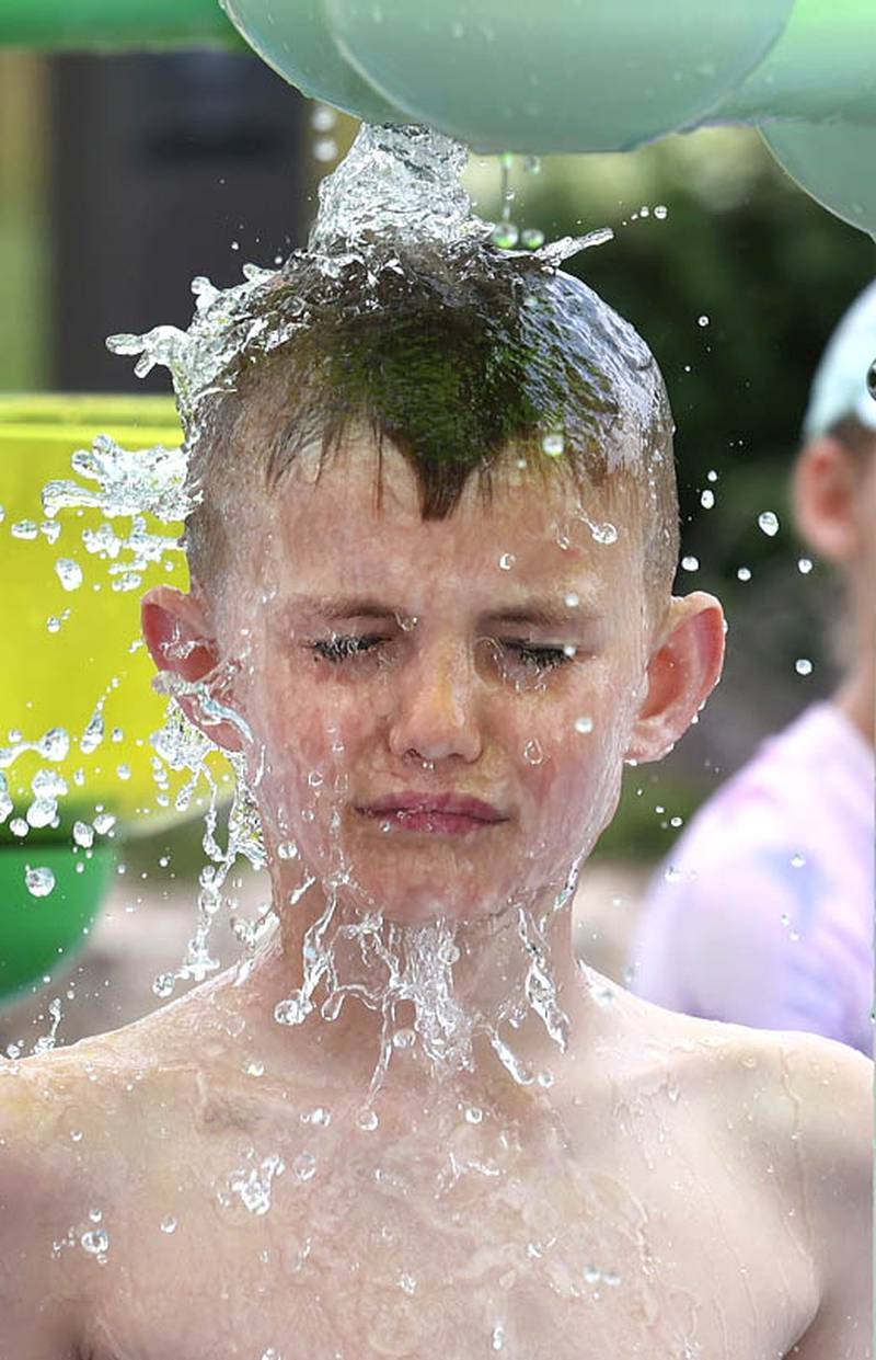 Rhett Hintzsche, 8, from Sycamore gets a face full of water Thursday, June 20, 2024, at Splash Fountain Splashpad at the Sycamore Park District’s Legacy Campus on Airport Road. High temperatures have been over 90 degrees every day this week making splash pads and pools very popular destinations.