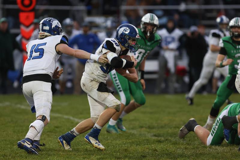 Clifton Central senior quarterback Brady Shule hands off to Everett Bailey during Dwight's 43-14 victory over Clifton Central in second round playoffs on Saturday, Nov. 8, 2025.