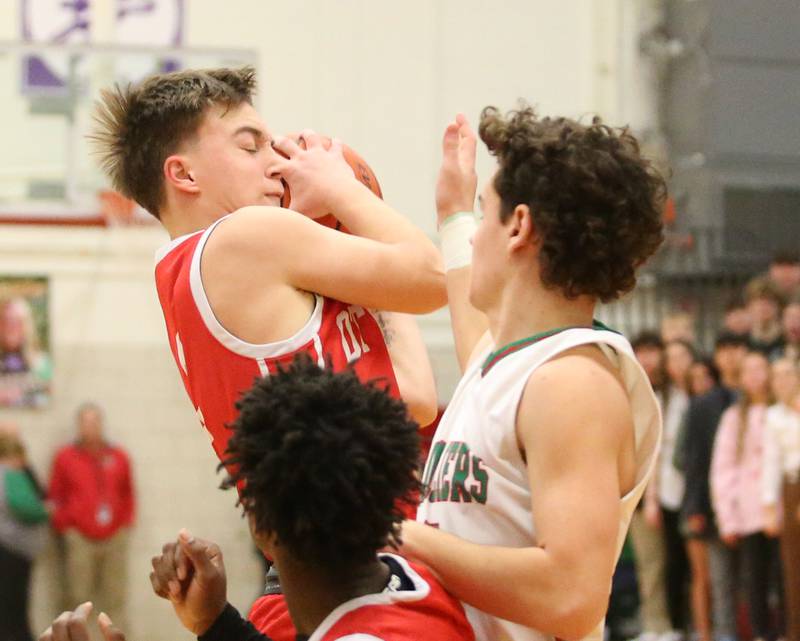 Ottawa's Huston Hart grabs a rebound over L-P's Michael Hartman on Friday, Jan. 5, 2024 at Sellett Gymnasium.