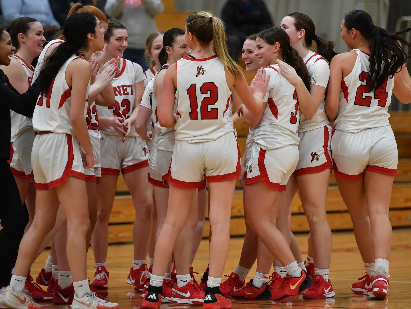 Benet teammates surround Aria Mazza (third from right) after she scored her thousandth career point during a game against Marist on January 8, 2025 at Benet Academy in Lisle.