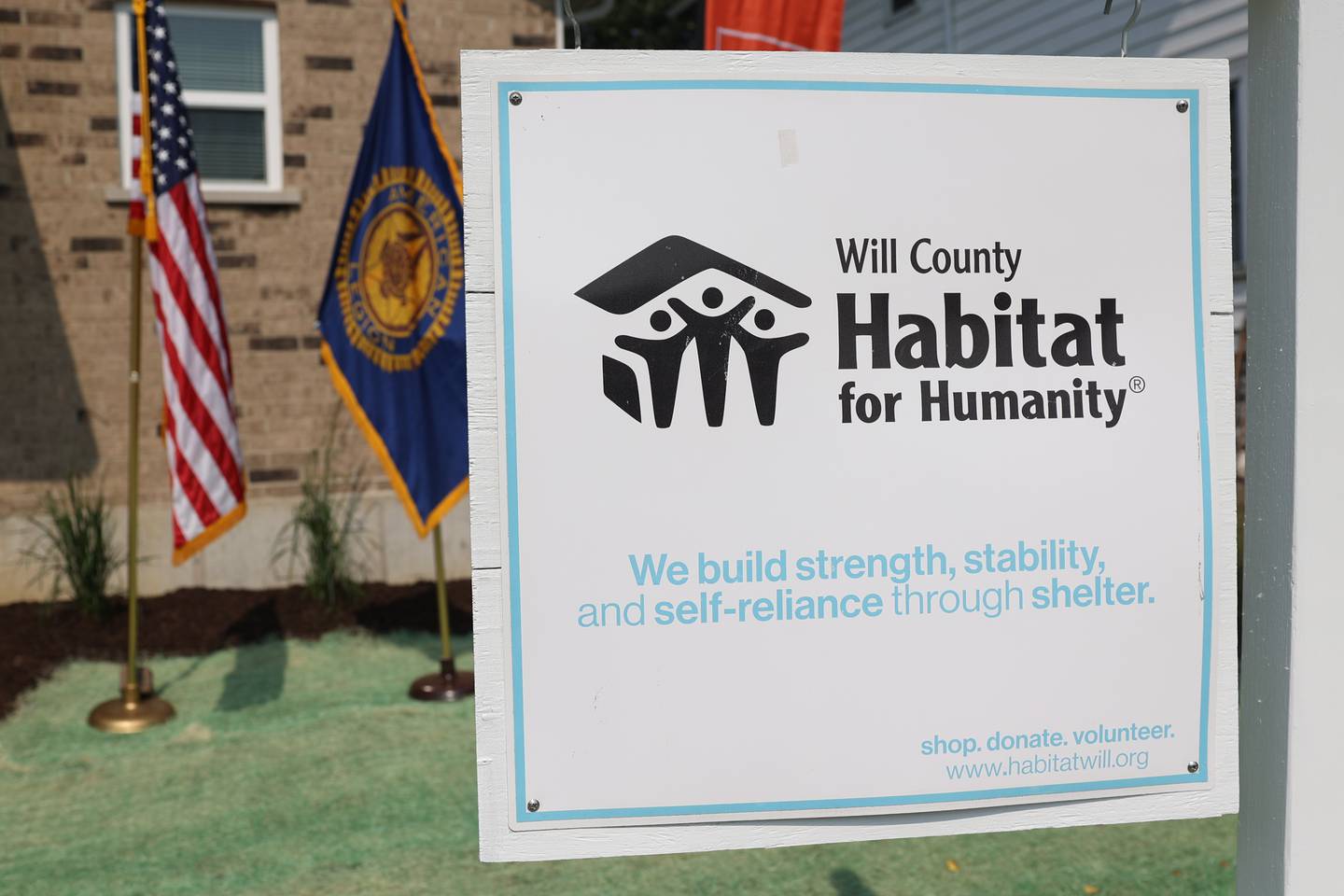 A Habitat for Humanity sign hangs in the yard of a new home at the Will County Habitat for Humanity official presentation of Army veteran Joe Murdie’s new home on Saturday, June 17, 2023 in Crest Hill.