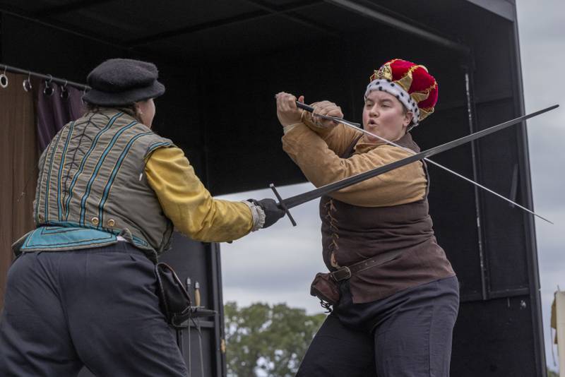 Two members of the act "They Fight" perform comedic versions of classic stories on stage Saturday, Sept. 28, 2024, at the Cedar Creek Ranch Renaissance Faire at Cedar Creek Ranch.