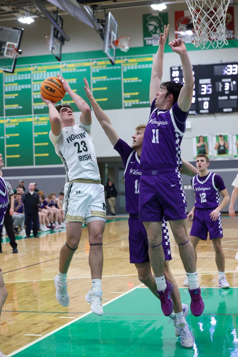 Bishop McNamara's Karter Krutsinger shoots under pressure from Wilmington's Ryan Kettman (11) and Ryker Feil during Bishop McNamara's 61-24 victory over Wilmington in the IHSA Class 2A Seneca Sectional semifinal on Tuesday, March 3, 2026.