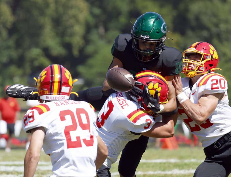 Glenbard West's Brady Johnson (80) tries in vain to pull in a long pass as Batavia's Matt Hansen (29) Drew DiBiase (3) and Chase Osborne (20) pressure him Saturday, Aug. 31, 2024 at Duchon Field in Glen Ellyn. The pass fell incomplete.