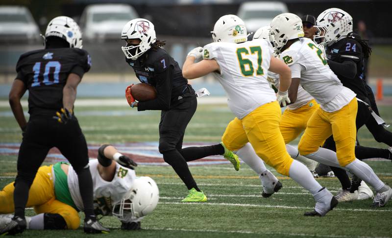 Kankakee's Dominic White carries the ball on a play in a Class 5A playoff against Providence Catholic on Saturday, November 8, 2025.