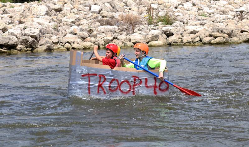 Participants of the cardboard boat race paddle down the Fox River at Yorkville River Fest on Saturday, July 19, 2025.