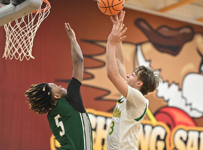 Providence Catholic Luke Rost (3) goes up a shot over Plainfield Central's Treyvon Smith (5) during the WJOL tournament game on Friday, NOV. 28, 2025, at Joliet.