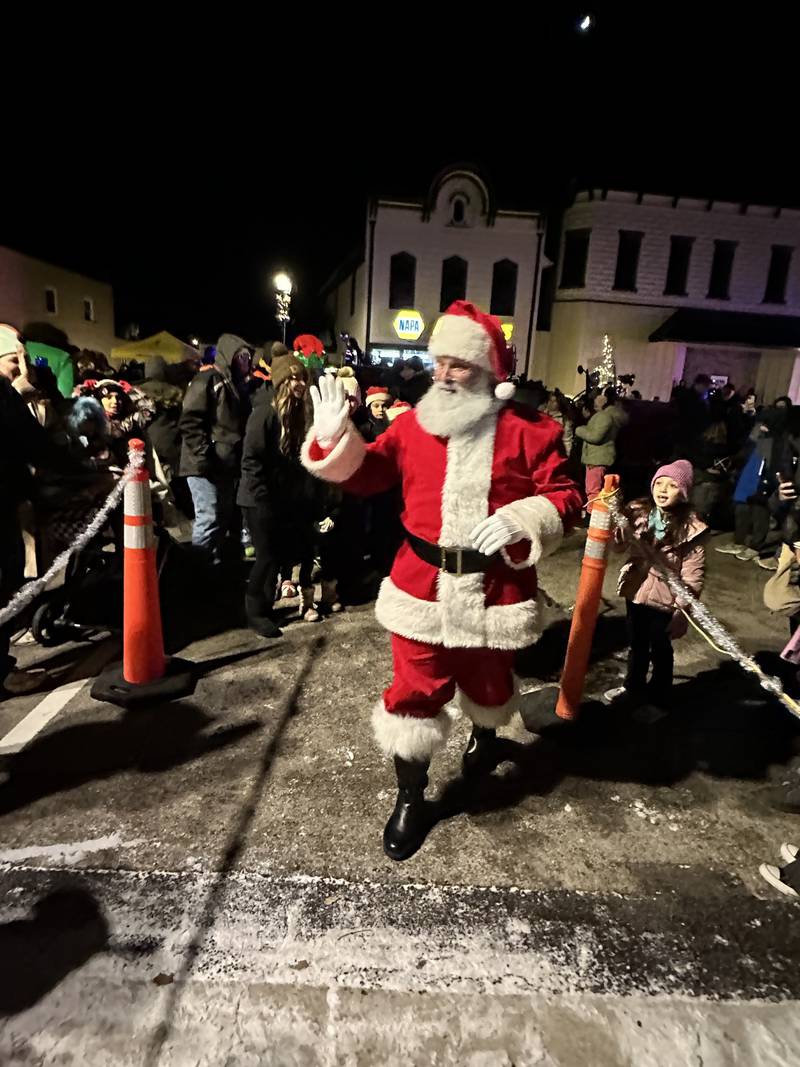 Santa Claus waves at the crowd during the 23rd annual Jingle Bell Parade during the Genoa Area Chamber of Commerce's annual Celebrate the Season holiday event on Dec. 6, 2024, in downtown Genoa.