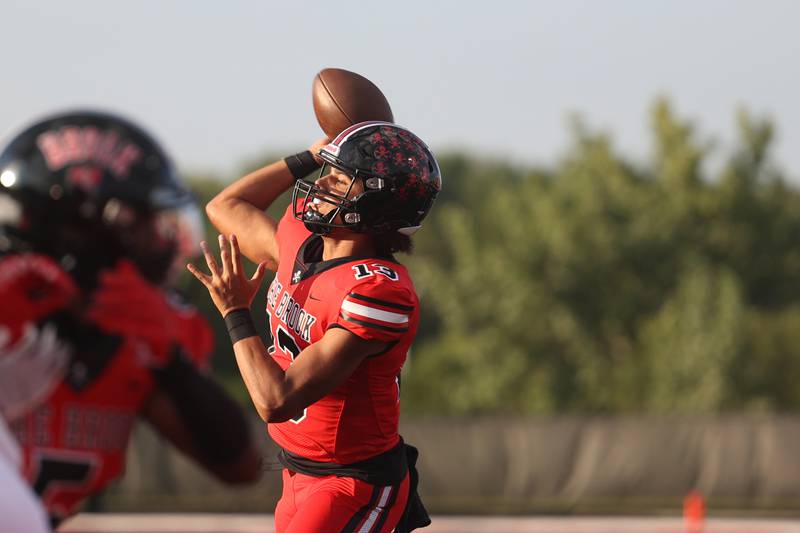 Bolingbrook’s Jonas Williams throws for a touchdown against Minooka. Friday, Aug. 26, 2022, in Bolingbrook.