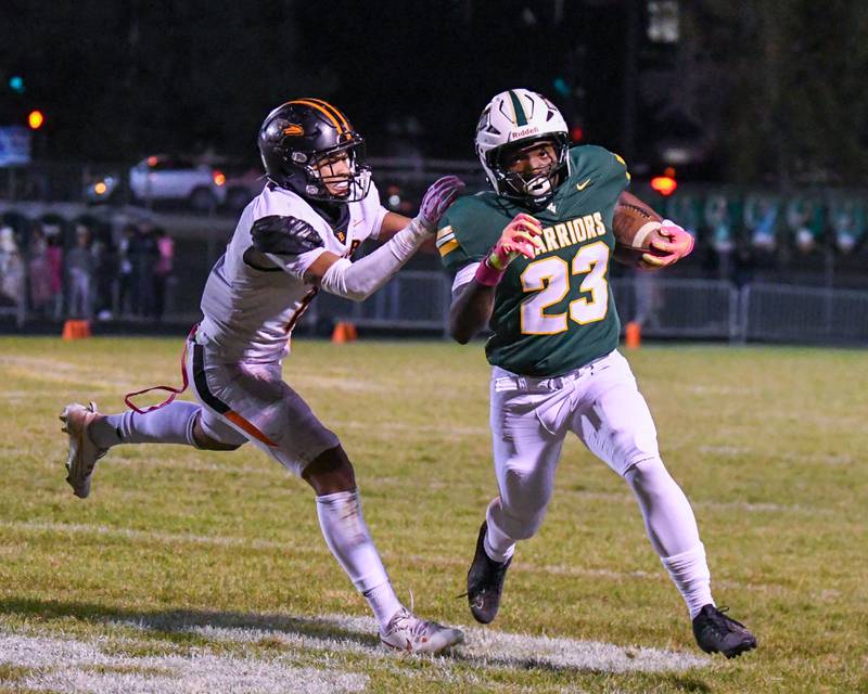 Waubonsie Valley's Ishmaiah Elliott (23) runs the ball before being pushed out of bounds by DeKalb's Patrick Davis (8) during the game on Friday Oct. 24, 2025, held at Waubonsie Valley High School.