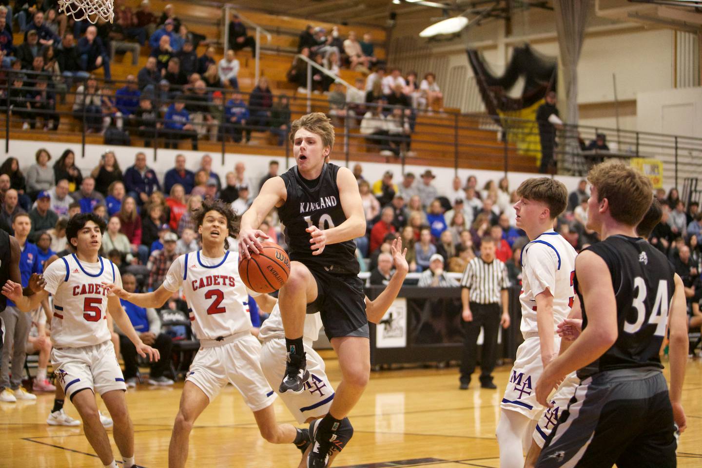 Kaneland's Troyer Carlson drives to the basket against Marmion Academy at the Class 3A Regional Final at Kaneland on Saturday, Feb.25, 2023.