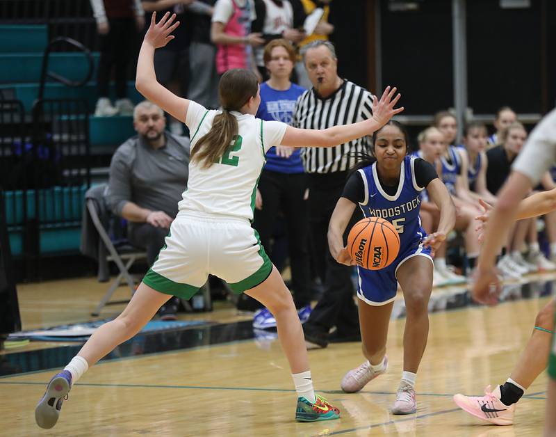 Woodstock's Salome Freites-Alvarado tries to pass the ball against the defense of Crystal Lake South's Gaby Dzik during the IHSA Class 3A Woodstock North Regional championship girls basketball game on Thursday, Feb. 19, 2026, at Woodstock North High School.