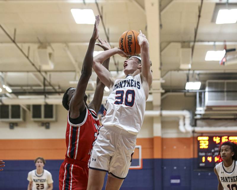 Oswego's Brayden Borrowman (30) puts up a shot off of a rebound during their basketball game between West Aurora at Oswego Monday, Nov 24, 2025 in Oswego.