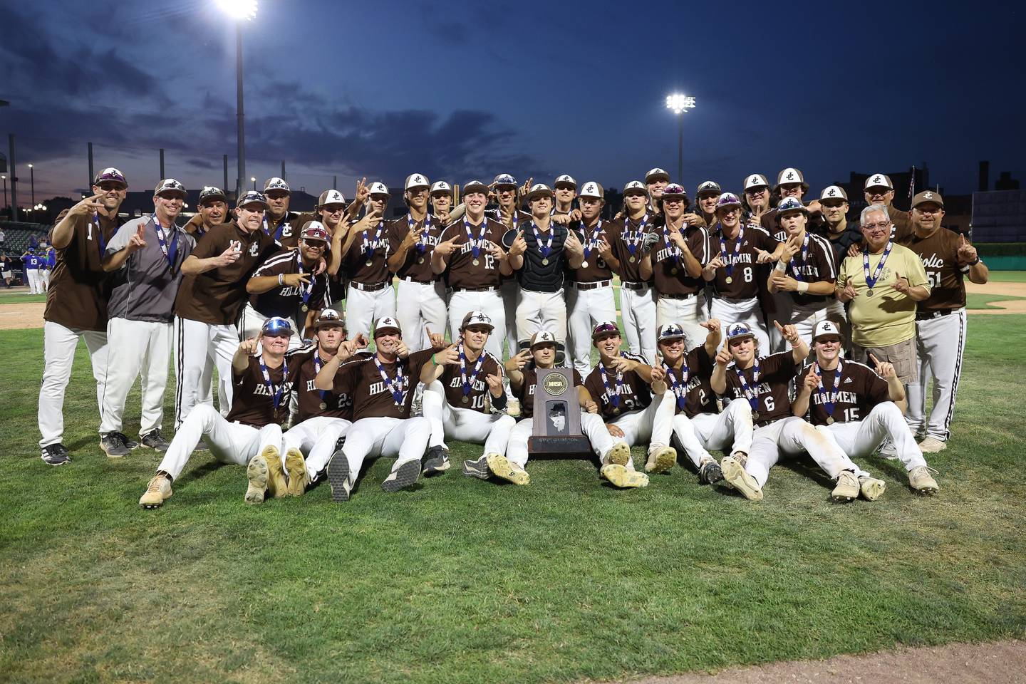 Joliet Catholic poses with championship trophy holding up two fingers, for their back-to-back championships, after a 4-2 win over Columbia in the IHSA Class 2A State Championship on Saturday, June 3, 2023 in Peoria.