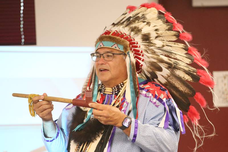 Gerald Savage, a tribal elder with the Ho-Chunk Nation, holds a prayer pipe during a program on Monday, Aug. 4, at the Richard A. Mautino Memorial Library in Spring Valley. Chief Savage spoke to about 40 people about the history of the Ho-Chunk Tribe, Native American instruments, stories and more. Chief Savage is an Illinois Humanities Road Scholar who speaks across the State and Wisconsin.