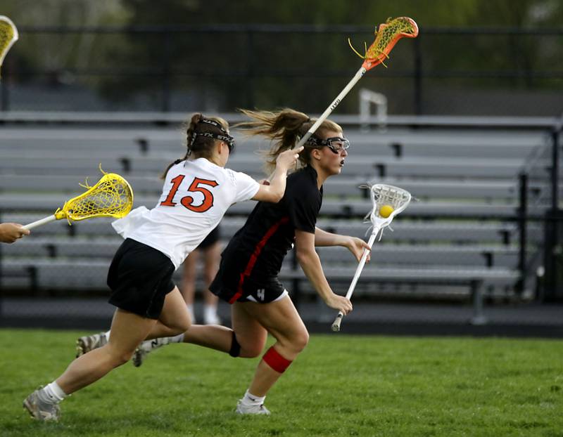 Crystal Lake Central co-op's Emma Sieg tries to slow down the attack of Huntley's Leah Holmberg during a Fox Valley Conference girls lacrosse match on Friday, April 17, 2026, at Crystal Lake Central High School.